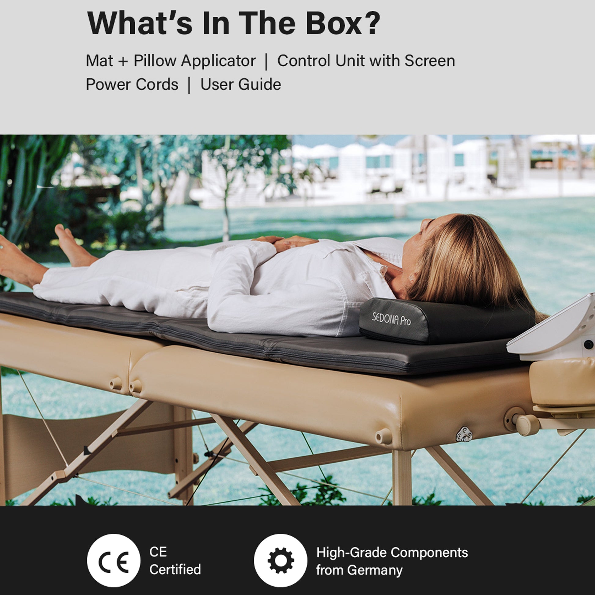 Box contents overview graphic for a massage mat and pillow set, with a woman lying on the tan massage table outdoors. Text reads 'What's In The Box?' and lists the included items, with CE Certified and High-Grade Components from Germany badges at the bottom.